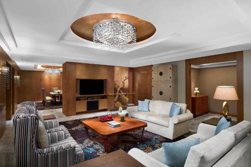 a living room with two couches and a table at Suzhou Marriott Hotel in Suzhou
