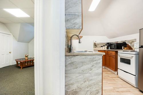 a kitchen with a sink and a stove top oven at Wolseley the heart of the city ! in Winnipeg