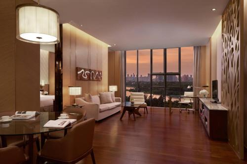 a living room with a couch and a room with a view at The OCT Harbour, Shenzhen - Marriott Executive Apartments in Shenzhen