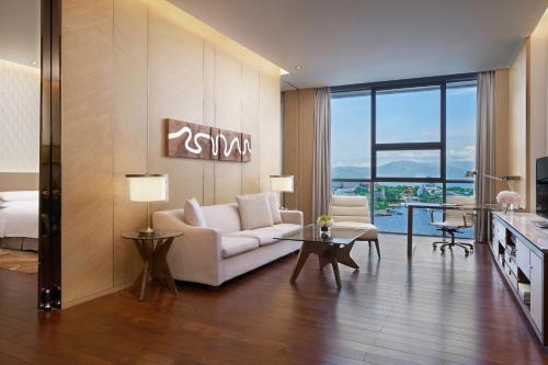 a living room with a couch and a table at The OCT Harbour, Shenzhen - Marriott Executive Apartments in Shenzhen