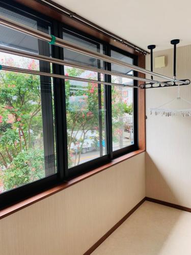 a room with windows and a view of a street at 道龍house in Azagawa