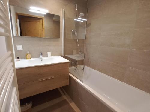 a bathroom with a sink and a shower and a tub at Appartement Valmorel, 3 pièces, 5 personnes - FR-1-356-422 in Valmorel