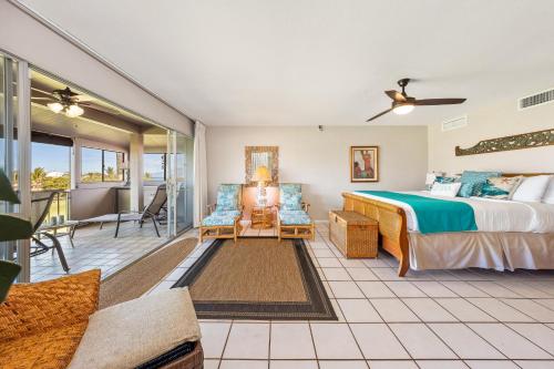 a bedroom with a bed and a balcony at Eldorado A203 in Kahana