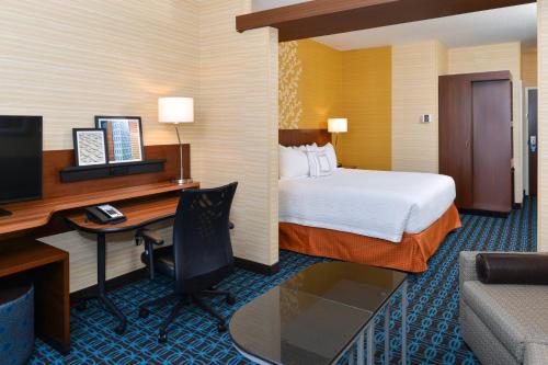 a hotel room with a bed and a desk with a computer at Fairfield Inn & Suites by Marriott Gallup in Gallup