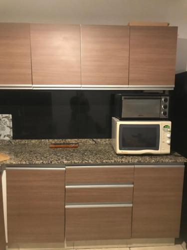 un horno microondas en la parte superior de una barra de cocina en Departamento Bombal en Godoy Cruz