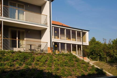 a large building with a yard in front of it at Jankovich Hotel in Rácalmás