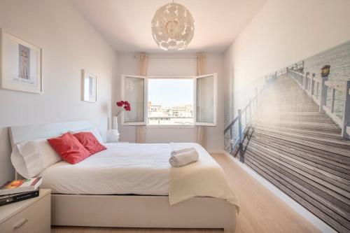 a white bedroom with a bed and a staircase at Stay U-nique Apartments Rambla Catalunya V in Barcelona
