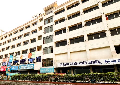 a large white building with writing on it at SPOT ON Srinivasa Residency in Tirupati