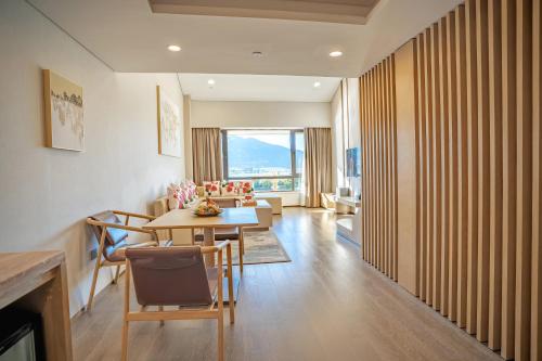 a living room with a table and chairs and a dining room at Hilton Lijiang in Lijiang
