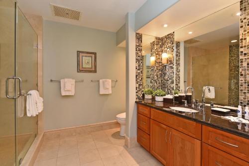 a bathroom with a sink and a toilet and a shower at Kaanapali Royal C202 in Lahaina