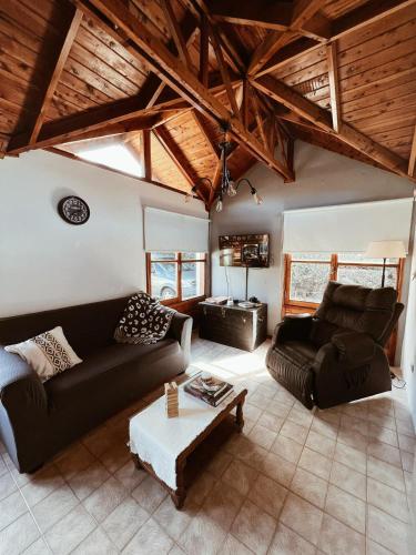 a living room with a couch and a table at Casa Arrayanes Tempo in Esquel