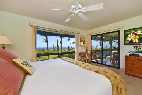 a bedroom with a bed and a view of the ocean at Kaanapali Plantation 8 in Lahaina