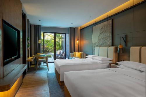 Habitación de hotel con 3 camas y TV en Renaissance Xiamen Hotel en Xiamen