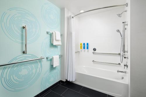 a bathroom with a shower and a white tub at Tru By Hilton Charleston Airport, Sc in Charleston