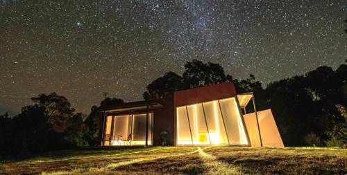 a building under a starry sky at night at Mt Singapore Villas - Villa 2 in Yanakie