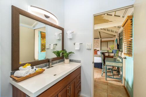 a bathroom with a sink and a mirror at International Colony Club 34 in Lahaina