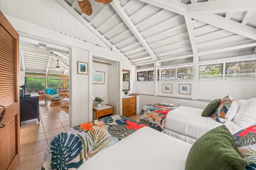 a bedroom with two beds and a living room at International Colony Club 34 in Lahaina