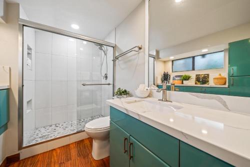 a bathroom with a toilet and a sink and a shower at International Colony Club 13 in Lahaina