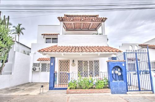 a house with a blue gate in front of it at Las Palmas Golden Zone Duplex - Pool & Sunset Rooftop in Bucerías