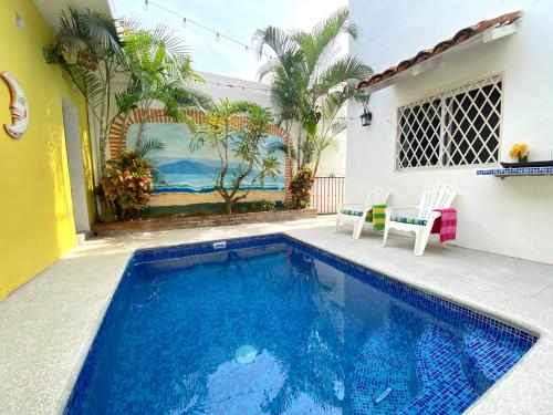 a swimming pool in the backyard of a house at Las Palmas Golden Zone Duplex - Pool & Sunset Rooftop in Bucerías