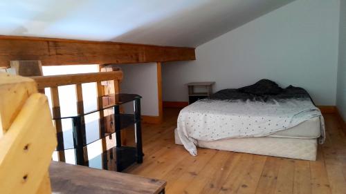 une chambre avec un lit et un parquet dans l'établissement Studio confortable avec piscine privée à Vassens - 16 m², à Tartiers