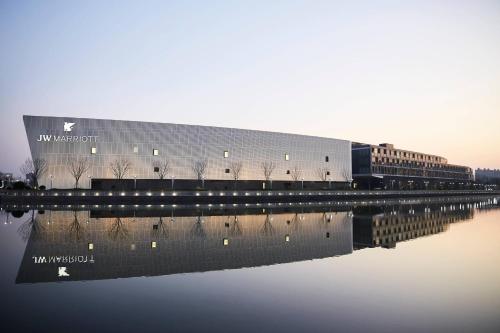 a large building next to a body of water at JW Marriott Shanghai Fengxian in Shanghai