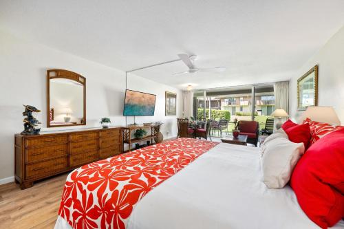 a bedroom with a large bed with a red and white blanket at Eldorado J111 in Kahana