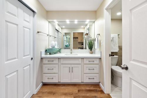 a white bathroom with a sink and a toilet at Eldorado J111 in Kahana