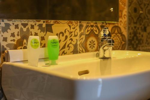 a bathroom sink with two bottles of soap on it at The Baliem Hotel in Jimbaran