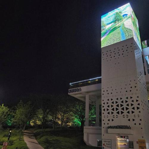a building with a billboard on the side of it at Exclusive House Hanok Stay 'Soo Hanok' in Suncheon