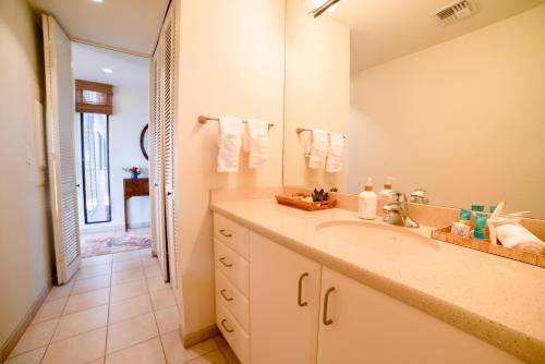 a bathroom with a sink and a large mirror at Wailea Ekahi 17D in Wailea