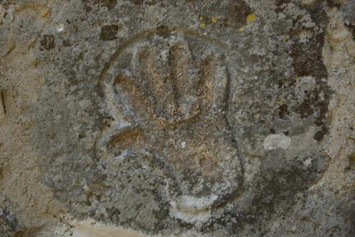 a paw print on a rock in the dirt at Canyon Matka Hotel in Matka