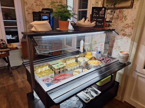 a refrigerator filled with different types of food at Hotel de Charme La Bonne Adresse - Logis hotels in Le Havre