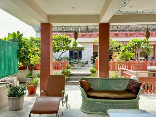 a lobby with a couch and chairs in a building at Suryaa Villa Jaipur - A Boutique Heritage Haveli in Jaipur