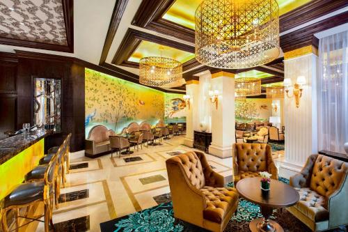 a lobby of a hotel with chairs and tables at The Castle Hotel, a Luxury Collection Hotel, Dalian in Dalian