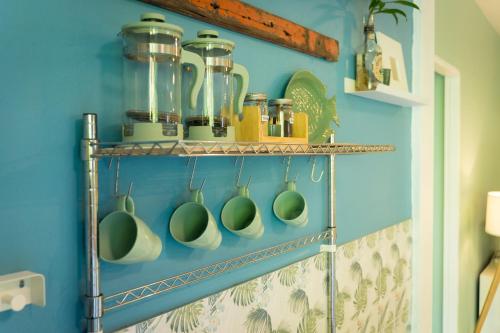 a shelf with utensils on a blue wall at Oasis Yoga Bungalows in Ko Lanta