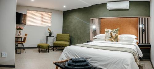 a bedroom with a large bed and a desk at 80 on Thabo in Potchefstroom