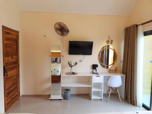 a room with a desk and a tv on a wall at private khaoyai in Mu Si