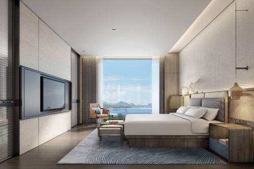 a bedroom with a bed and a large window at Courtyard by Marriott Liuzhou Sanjiang in Sanjiang