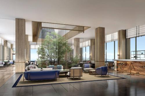a lobby with couches and chairs and windows at Courtyard by Marriott Liuzhou Sanjiang in Sanjiang