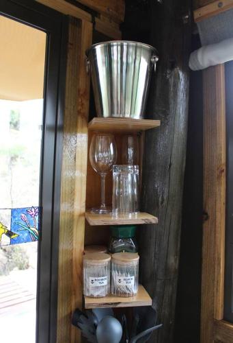 a wooden shelf with wine glasses and a bucket on it at Luxury Treehouse on Bronberg Ridge in Tierpoort