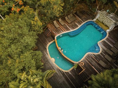 an overhead view of a swimming pool with chairs and trees at The Vatika Resort and Spa in Ao Nang Beach