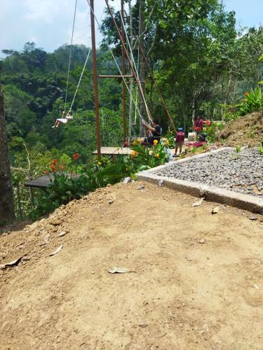 a group of people riding on a swing at Wahwik's House in Ubud