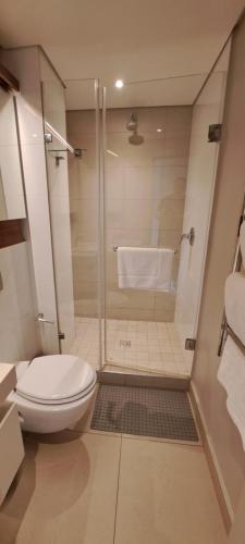 a bathroom with a shower with a toilet and a sink at Zimbali Suites 613 - 1 Bedroom in Ballito