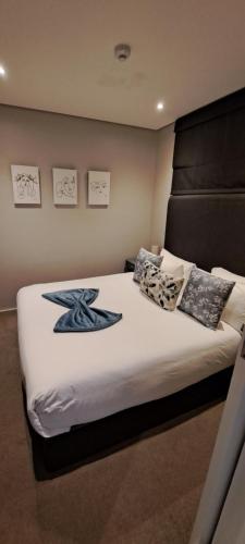 a bedroom with a large bed with pillows on it at Zimbali Suites 613 - 1 Bedroom in Ballito