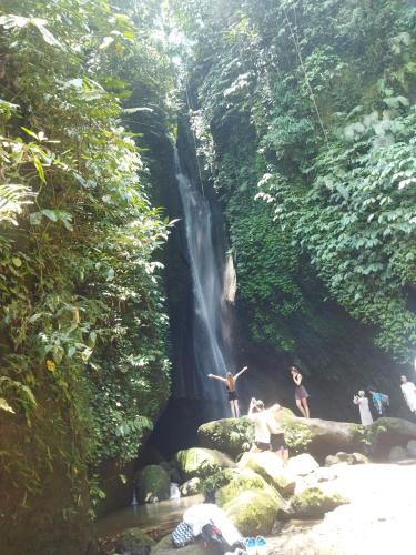 a group of people in front of a waterfall at Wahwik's House in Ubud