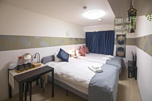 Kiyomizu Sannenzaka Home in Kyoto - Vacation STAY 34439v tesisinde bir odada yatak veya yataklar