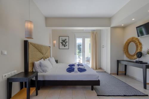 a bedroom with a bed and a table and a mirror at Kipo Paradiso Spa, Yoga & Gym Resort in Kiriánna