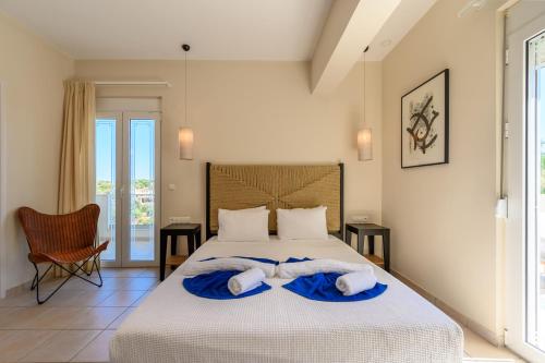 a bedroom with a bed with towels on it at Kipo Paradiso Spa, Yoga & Gym Resort in Kiriánna
