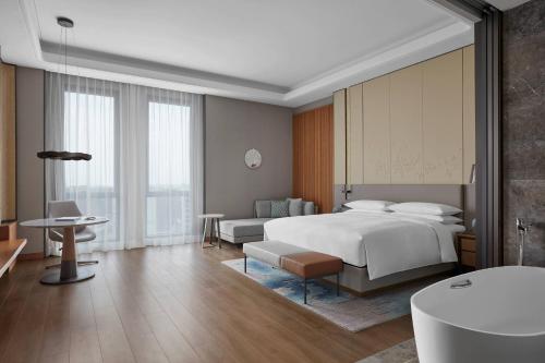 a hotel room with a bed and a bathroom at Wenzhou Airport Marriott Hotel in Wenzhou